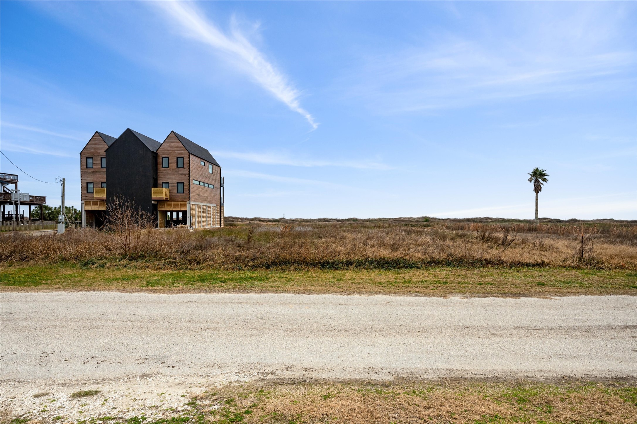 338 Atkinson Street Crystal Beach, TX 77650 - Photo 6 of 13 a view of a big room with a beach and a building