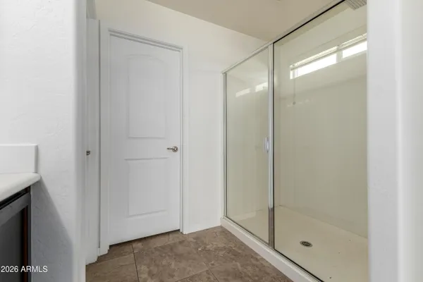 a bathroom with a glass shower door
