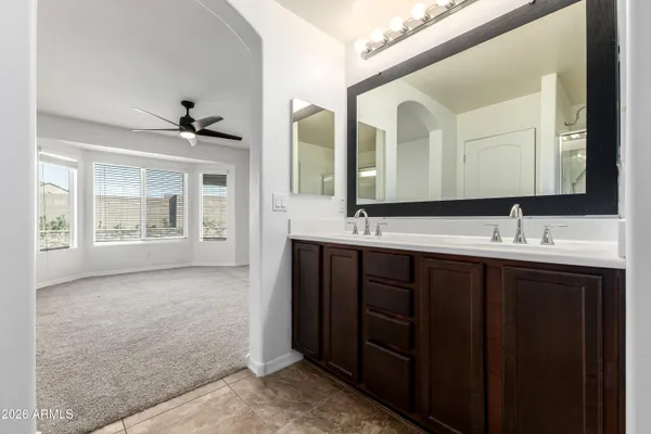 a bathroom with a double vanity sink and mirror