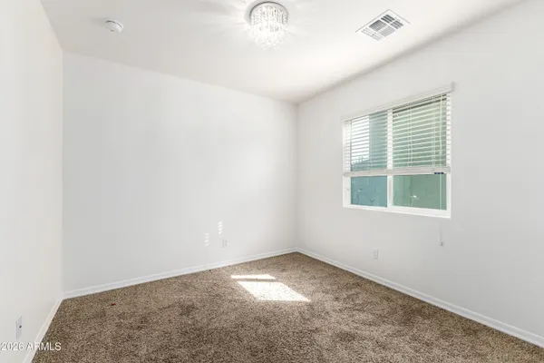 an empty room with a chandeliers