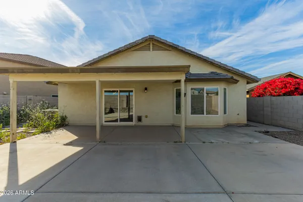 a house with yard and a wooden fence