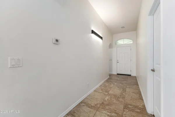 an empty room with entrance and mirror