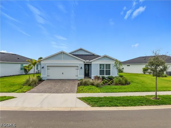 a front view of a house with a yard and garage