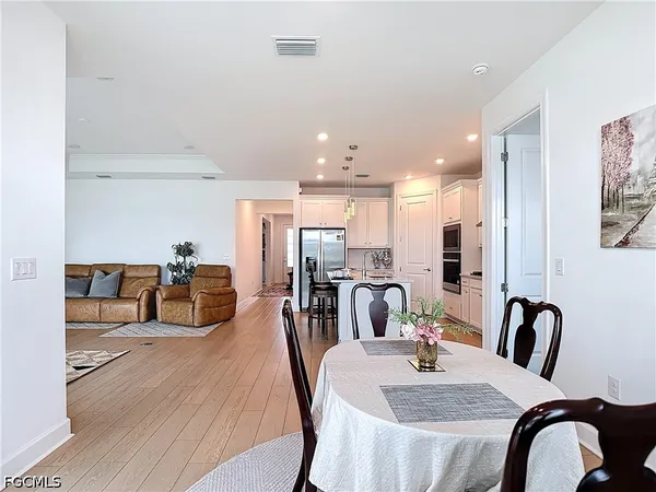 a dining room with furniture and wooden floor