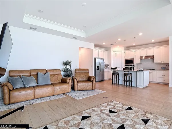 a living room with furniture and kitchen view