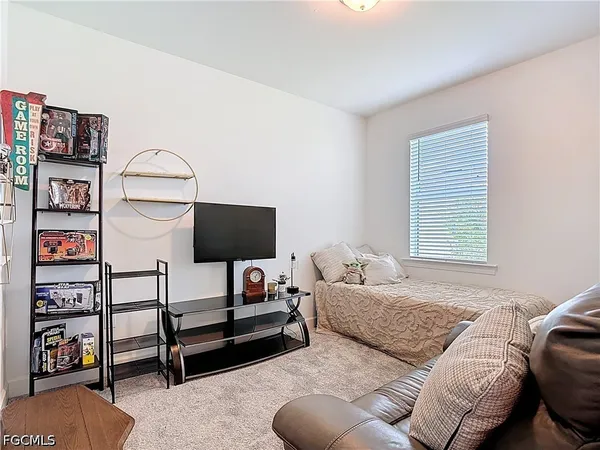 a bedroom with furniture and a window