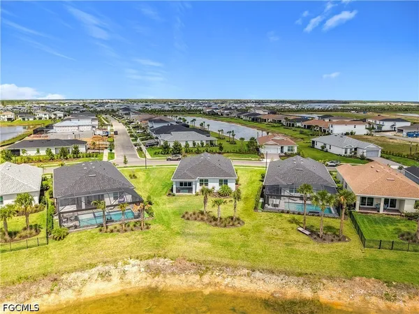 an aerial view of residential houses with outdoor space and swimming pool