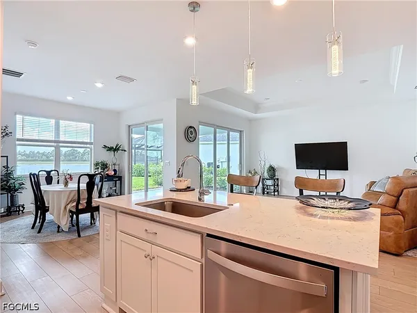 a kitchen with a table chairs stove and living room view