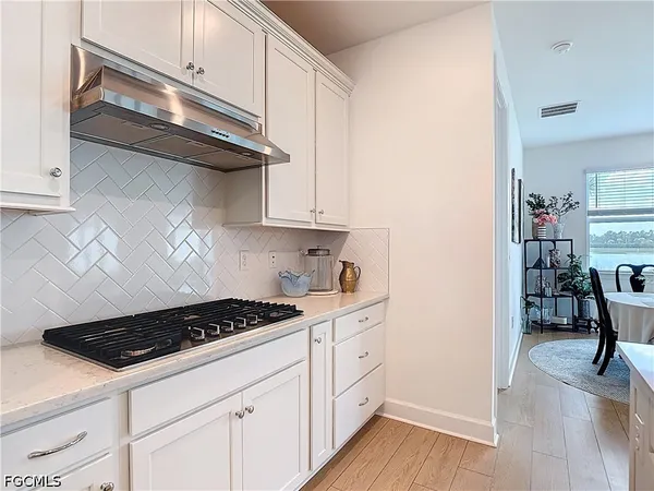 a kitchen with cabinets and a stove top oven