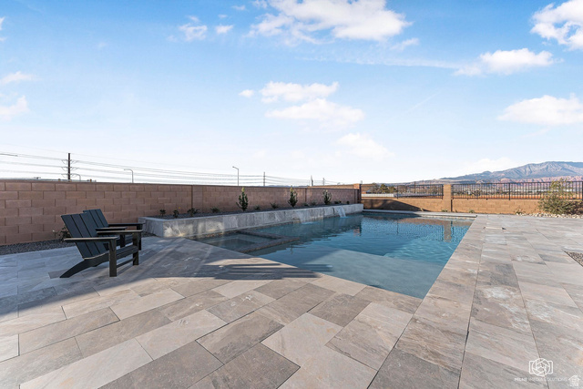 1468 South Red Cliffs Temple Lane St. George, UT 84790 - Photo 53 of 64 Relaxing pool / spa featuring a fenced backyard, a patio, and a mountain view