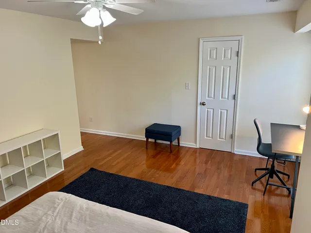 a bedroom with a bed and a chair