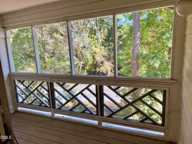 a view of a room with wooden floor and a window