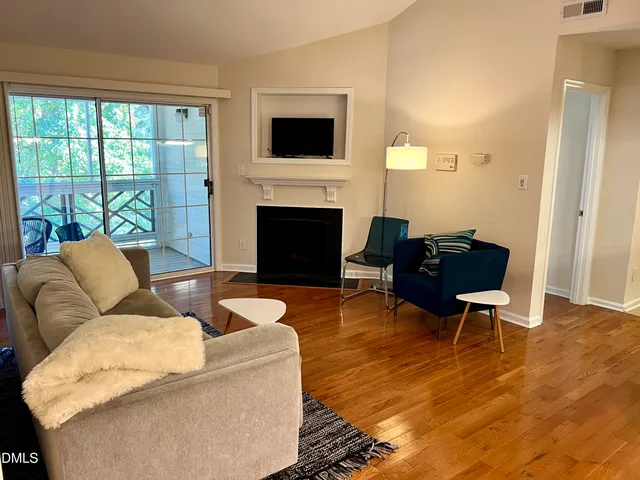 a living room with furniture fireplace and a flat screen tv
