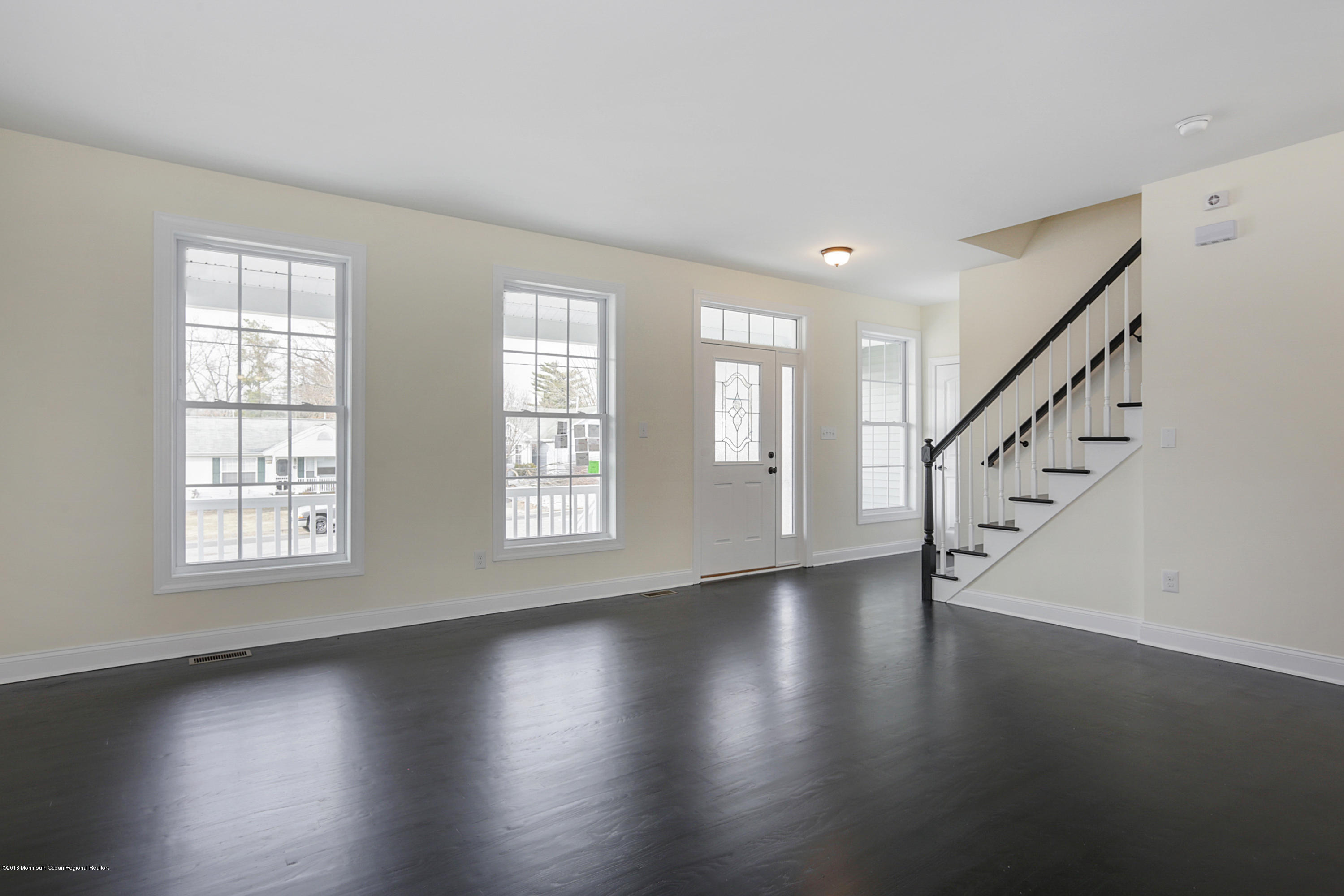 157 Bowline Road Manahawkin, NJ 08050 - Photo 8 of 29 a view of an empty room with wooden floor and a window