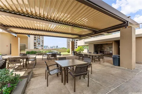 a view of a patio with table and chairs and potted plants