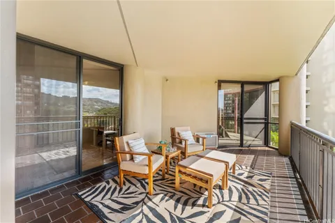 a living room with a large window and furniture