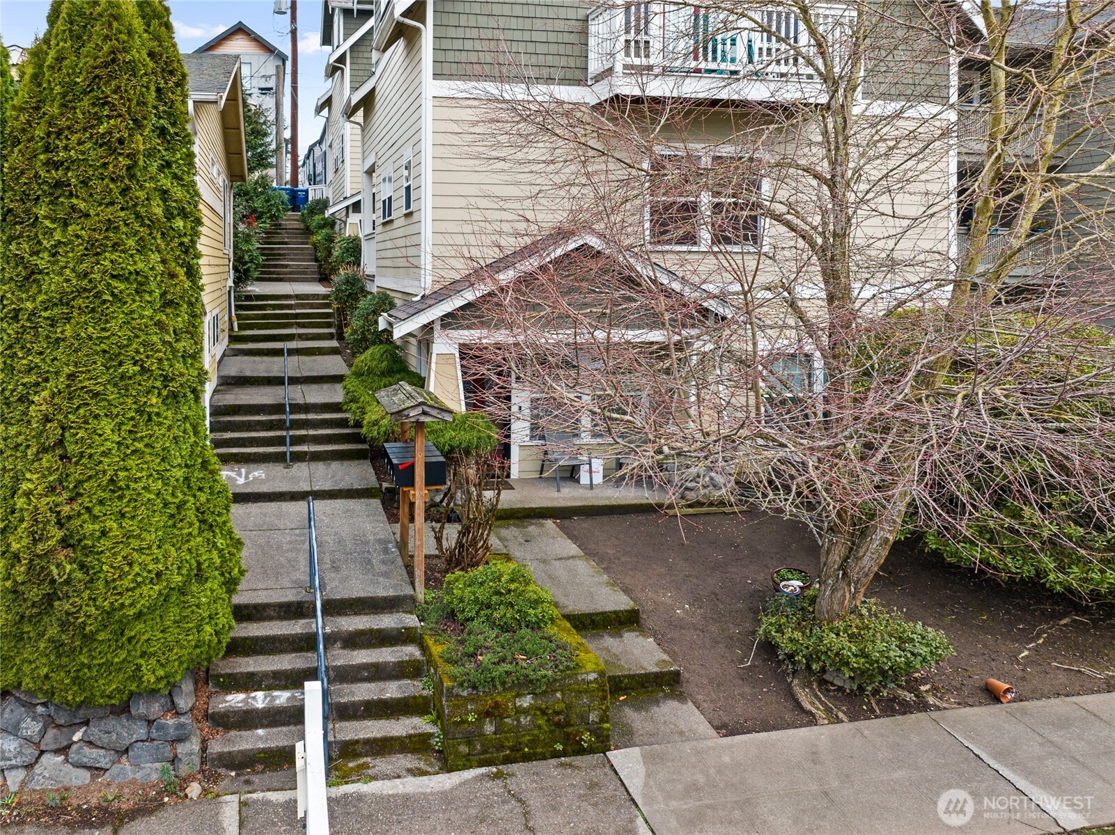 5907 40th Avenue Southwest, Unit B Seattle, WA 98136 - Photo 16 of 23 a front view of a house with a yard