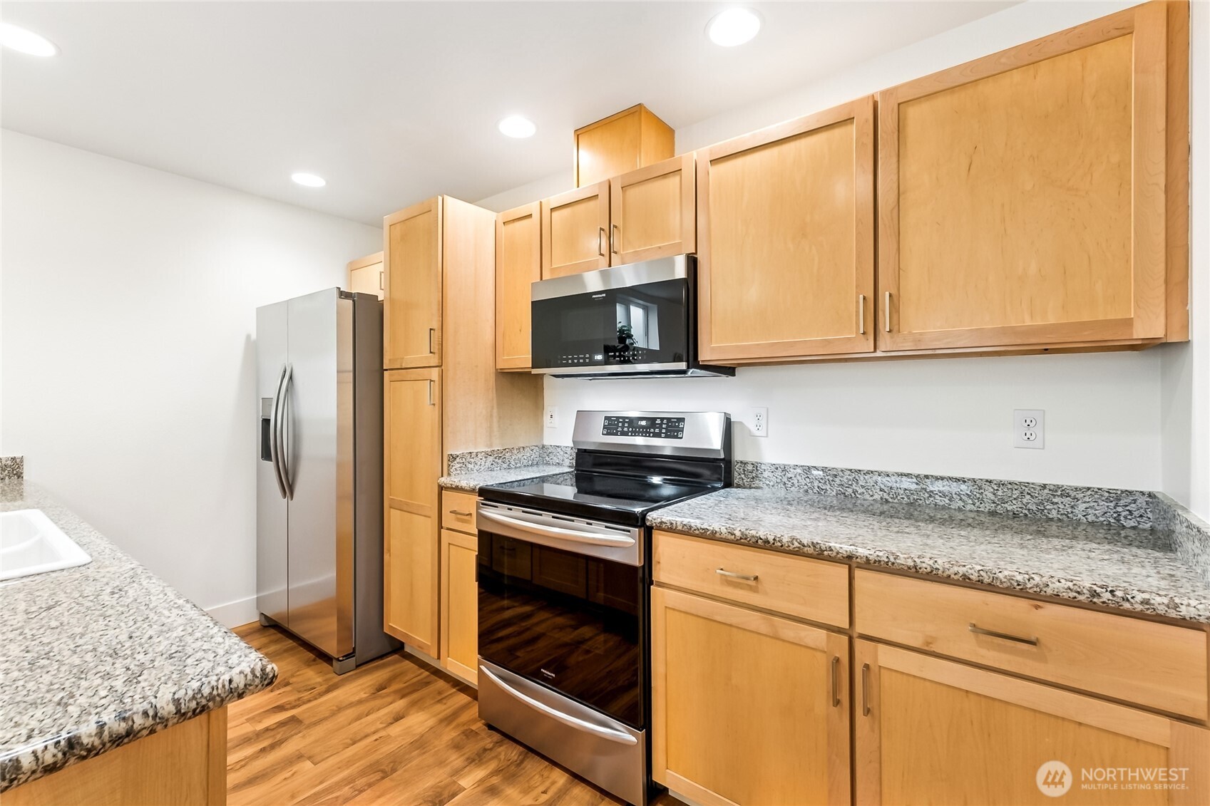 5907 40th Avenue Southwest, Unit B Seattle, WA 98136 - Photo 7 of 23 a kitchen with stainless steel appliances granite countertop a stove a refrigerator and a microwave
