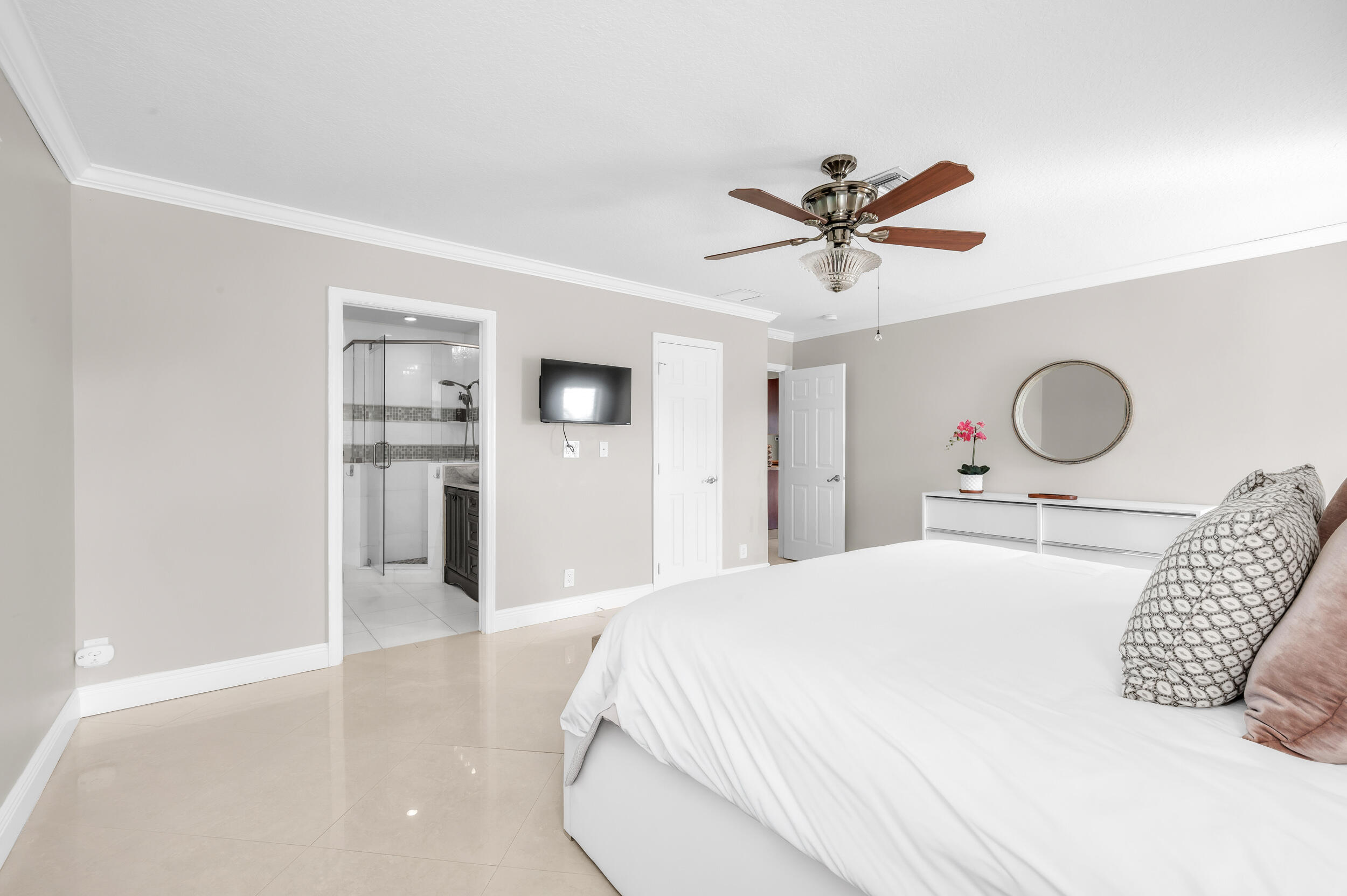 3250 Lakeview Boulevard Delray Beach, FL 33445 - Photo 15 of 26 a bedroom with a bed and cabinets
