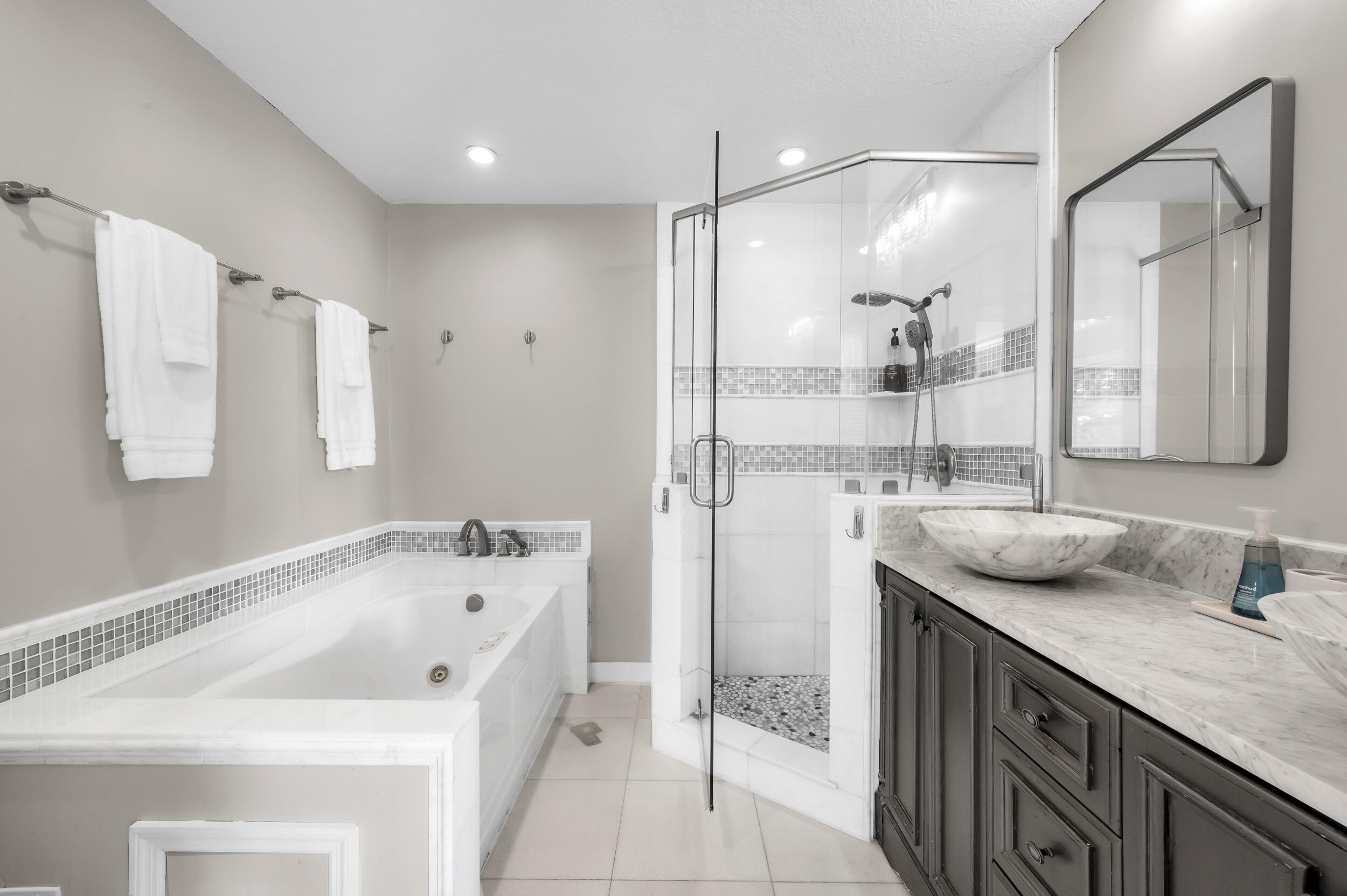 3250 Lakeview Boulevard Delray Beach, FL 33445 - Photo 16 of 26 a bathroom with a tub sink and mirror