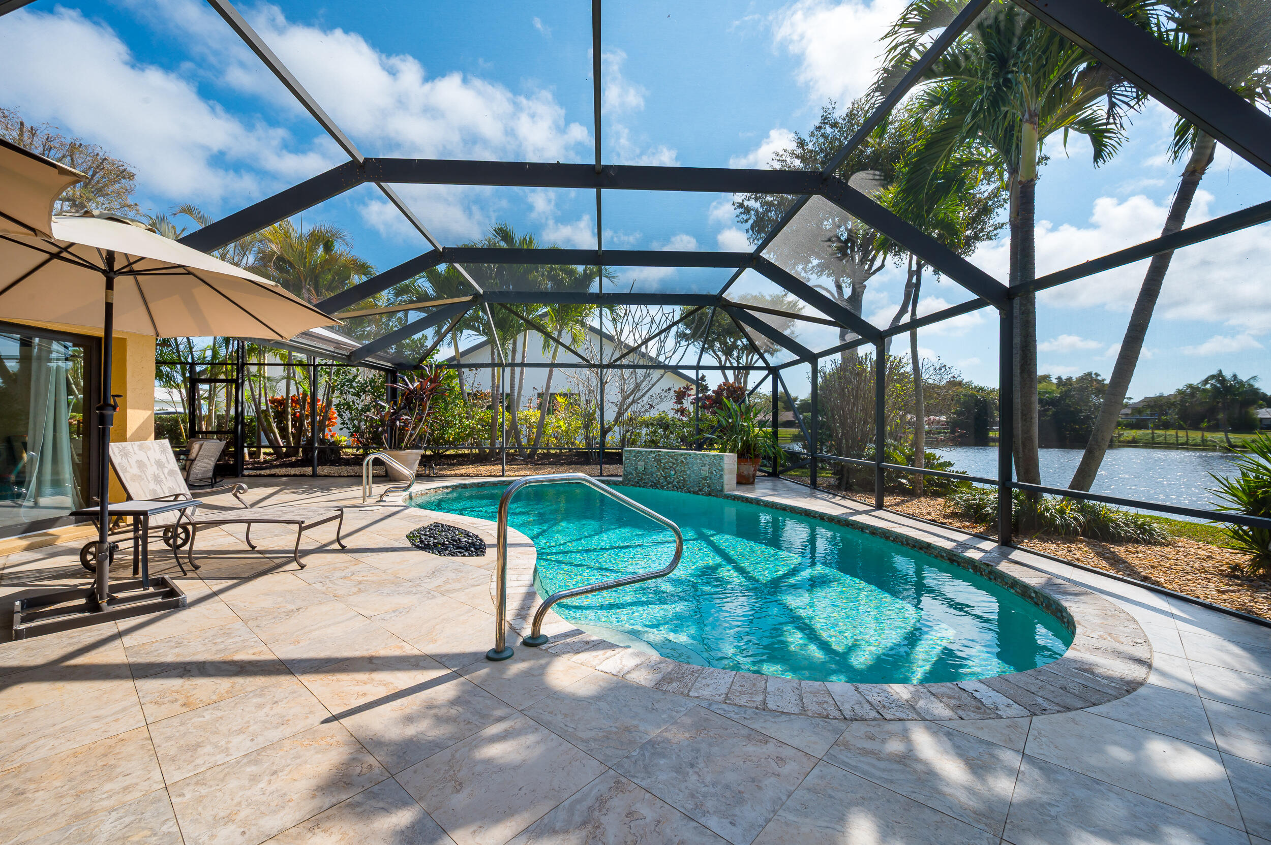 3250 Lakeview Boulevard Delray Beach, FL 33445 - Photo 20 of 26 a view of a swimming pool with a patio