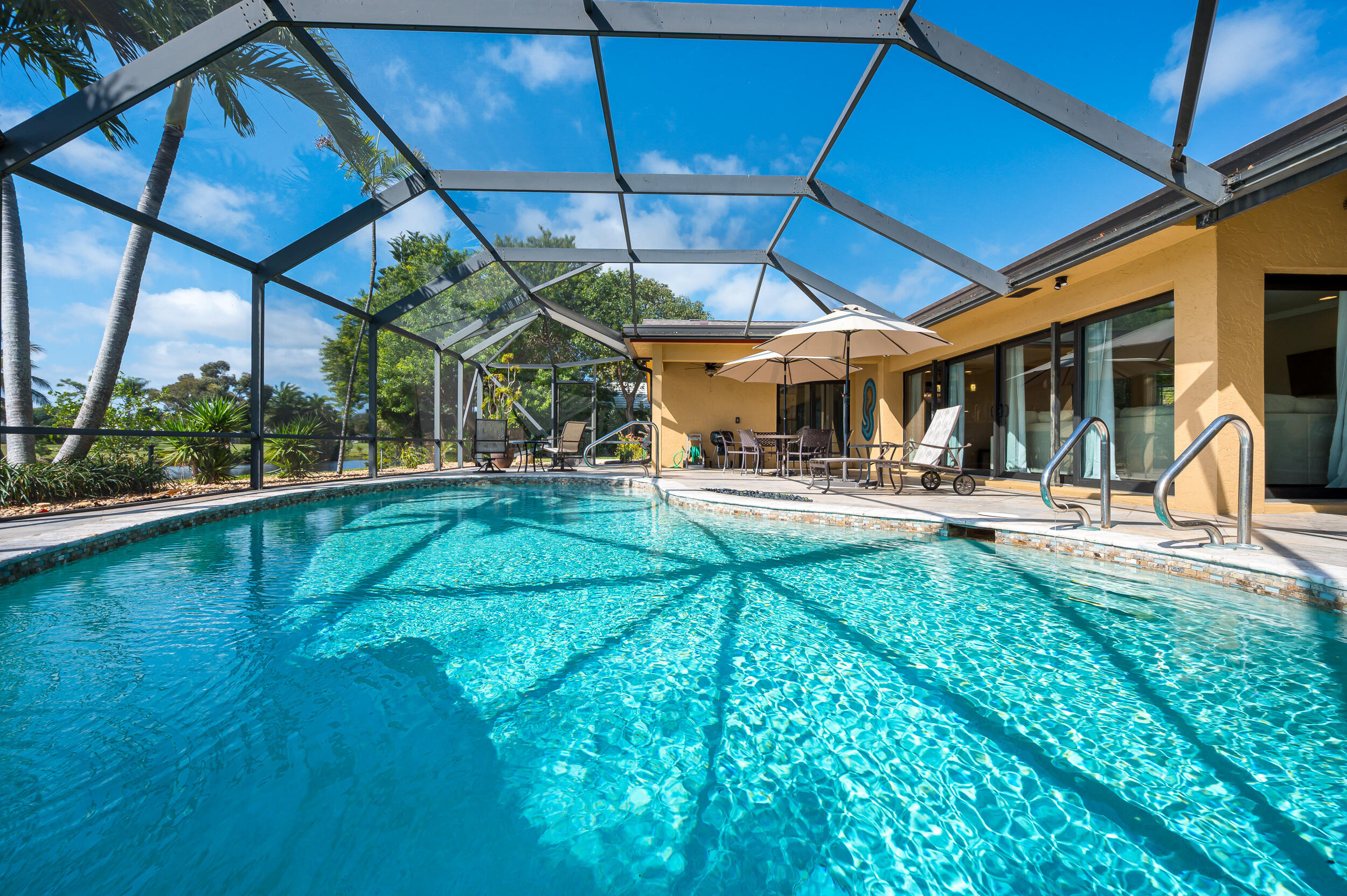 3250 Lakeview Boulevard Delray Beach, FL 33445 - Photo 23 of 26 a view of a swimming pool with a patio