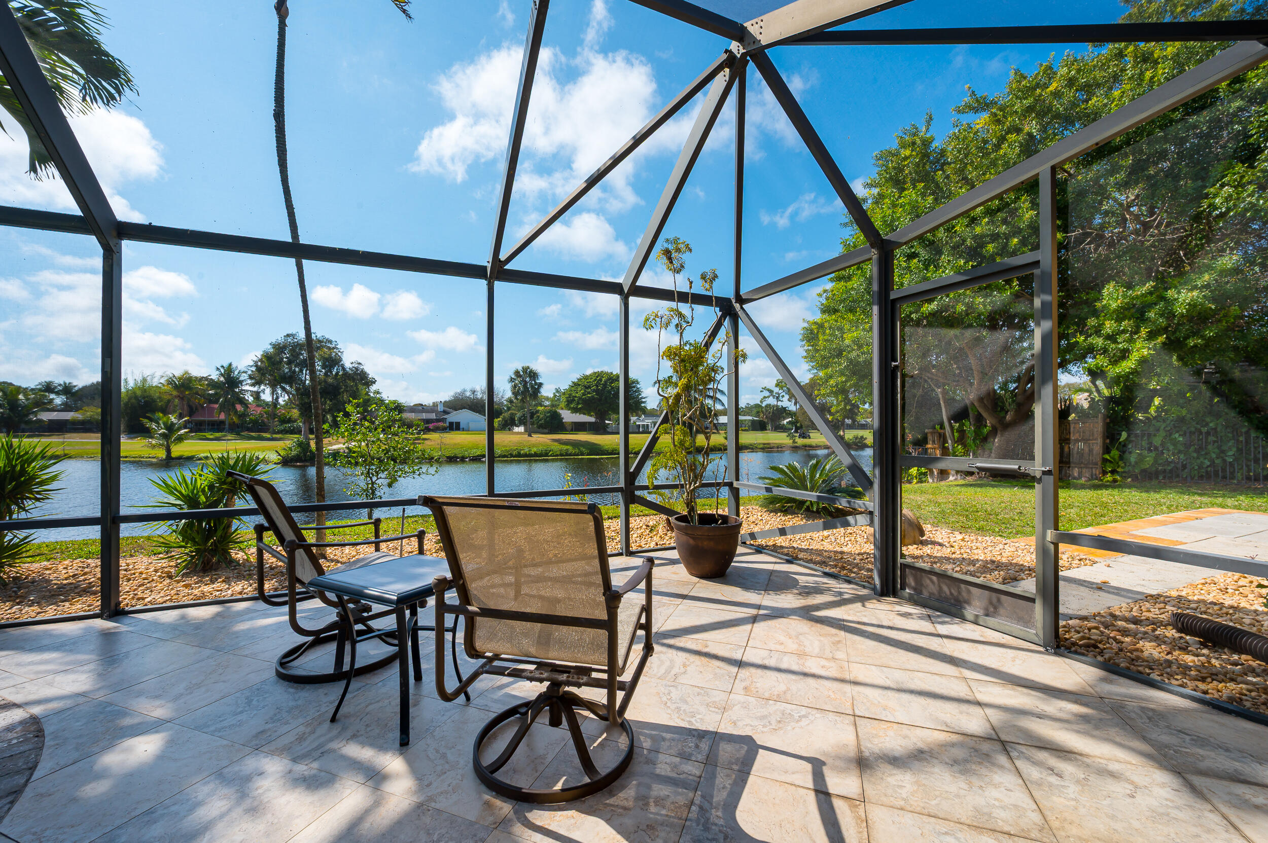3250 Lakeview Boulevard Delray Beach, FL 33445 - Photo 25 of 26 a view of a swimming pool with chairs in patio