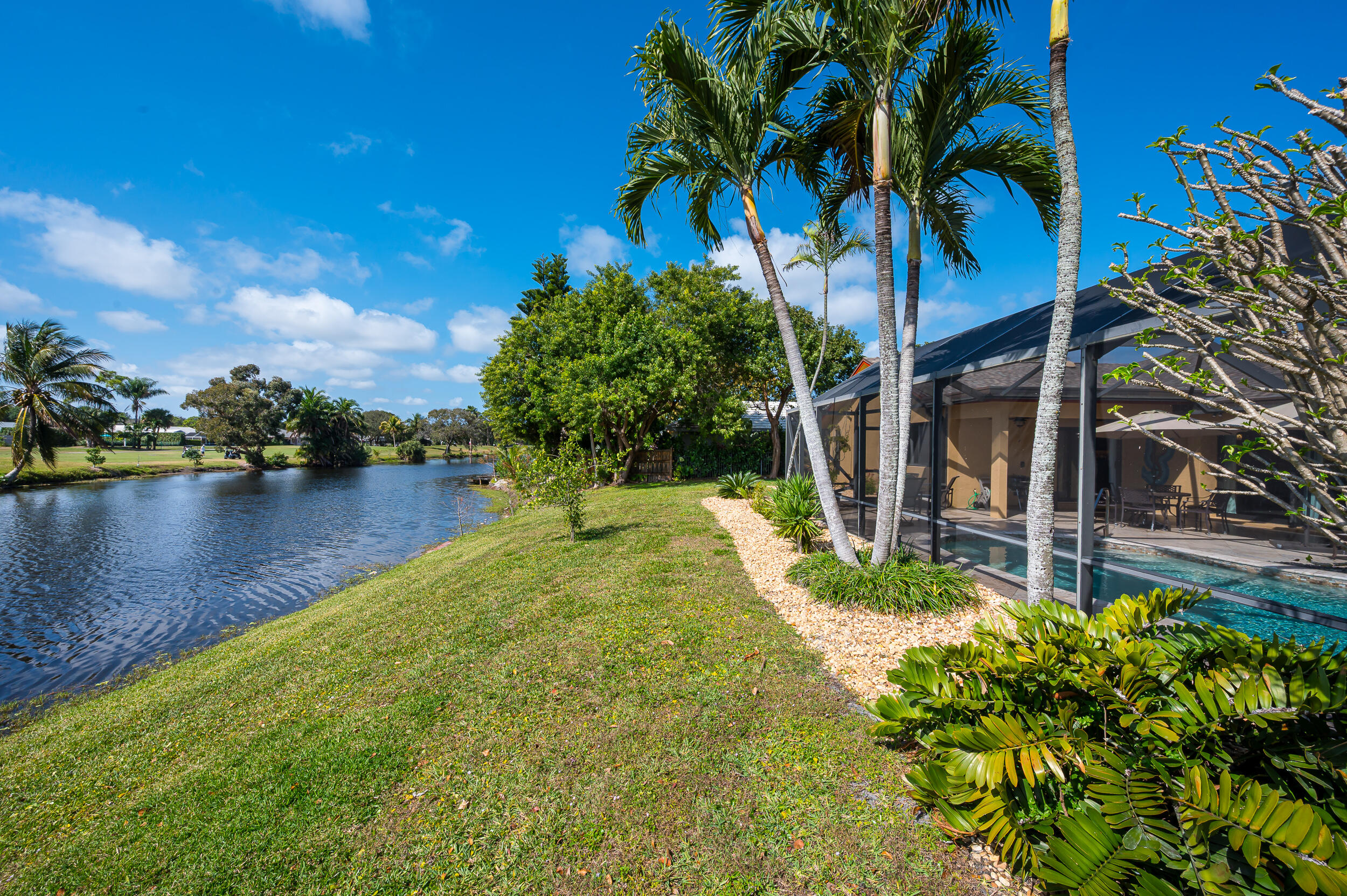 3250 Lakeview Boulevard Delray Beach, FL 33445 - Photo 26 of 26 a view of a backyard with plants and a lake view