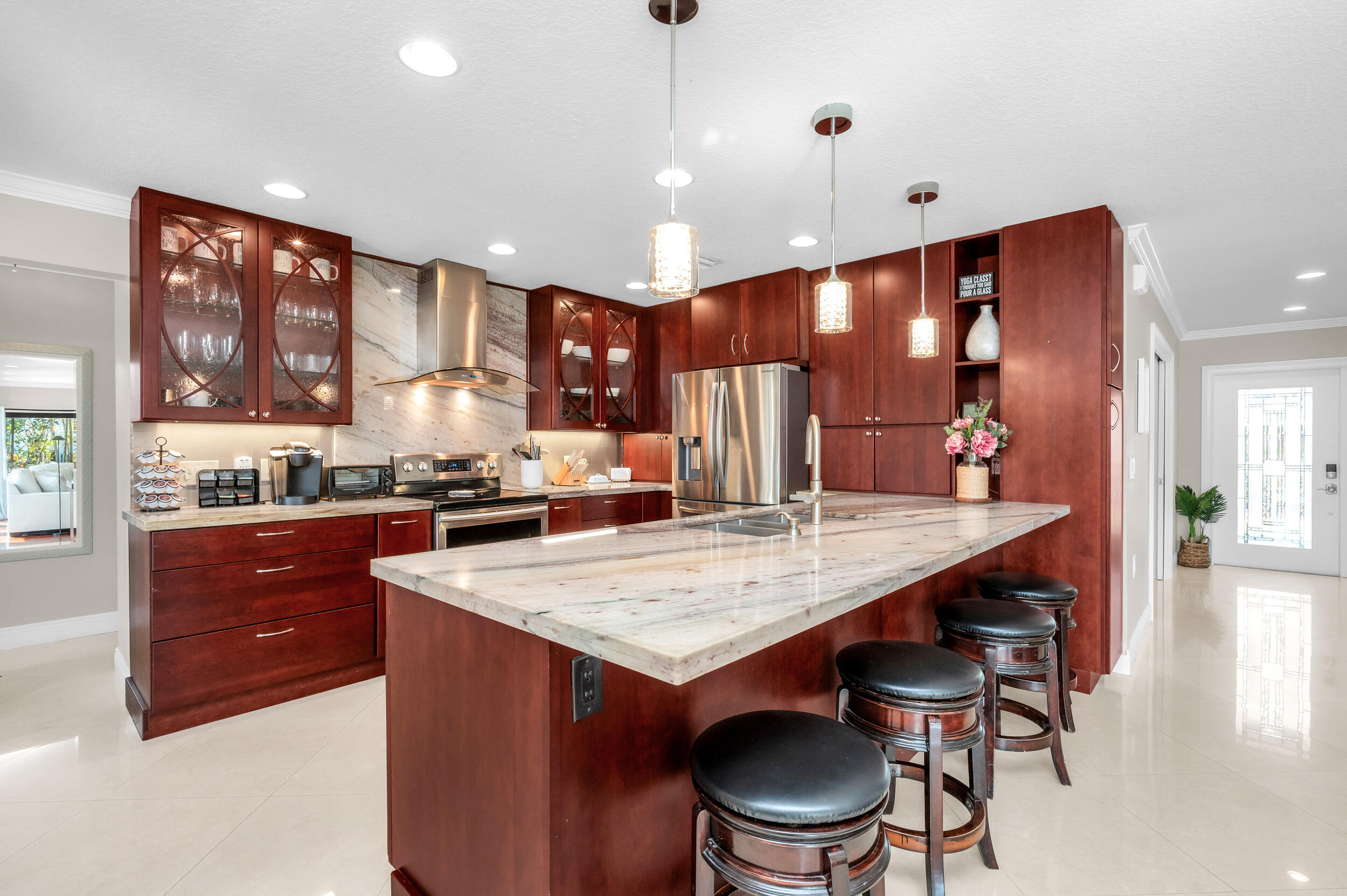 3250 Lakeview Boulevard Delray Beach, FL 33445 - Photo 7 of 26 a kitchen with a stove a refrigerator and a dining table