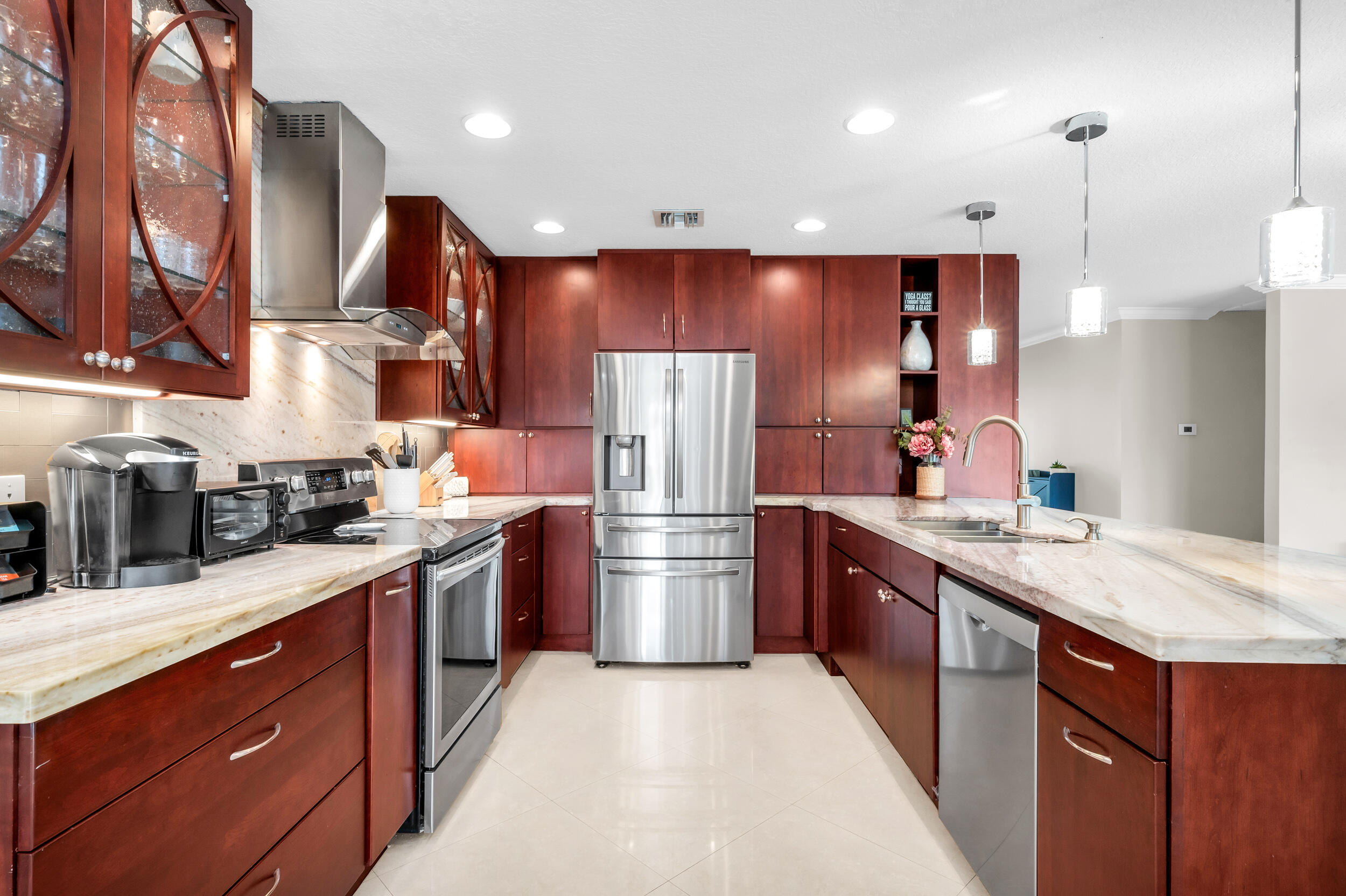 3250 Lakeview Boulevard Delray Beach, FL 33445 - Photo 8 of 26 a kitchen with stainless steel appliances granite countertop a refrigerator a sink dishwasher a oven and wooden cabinets with wooden floor