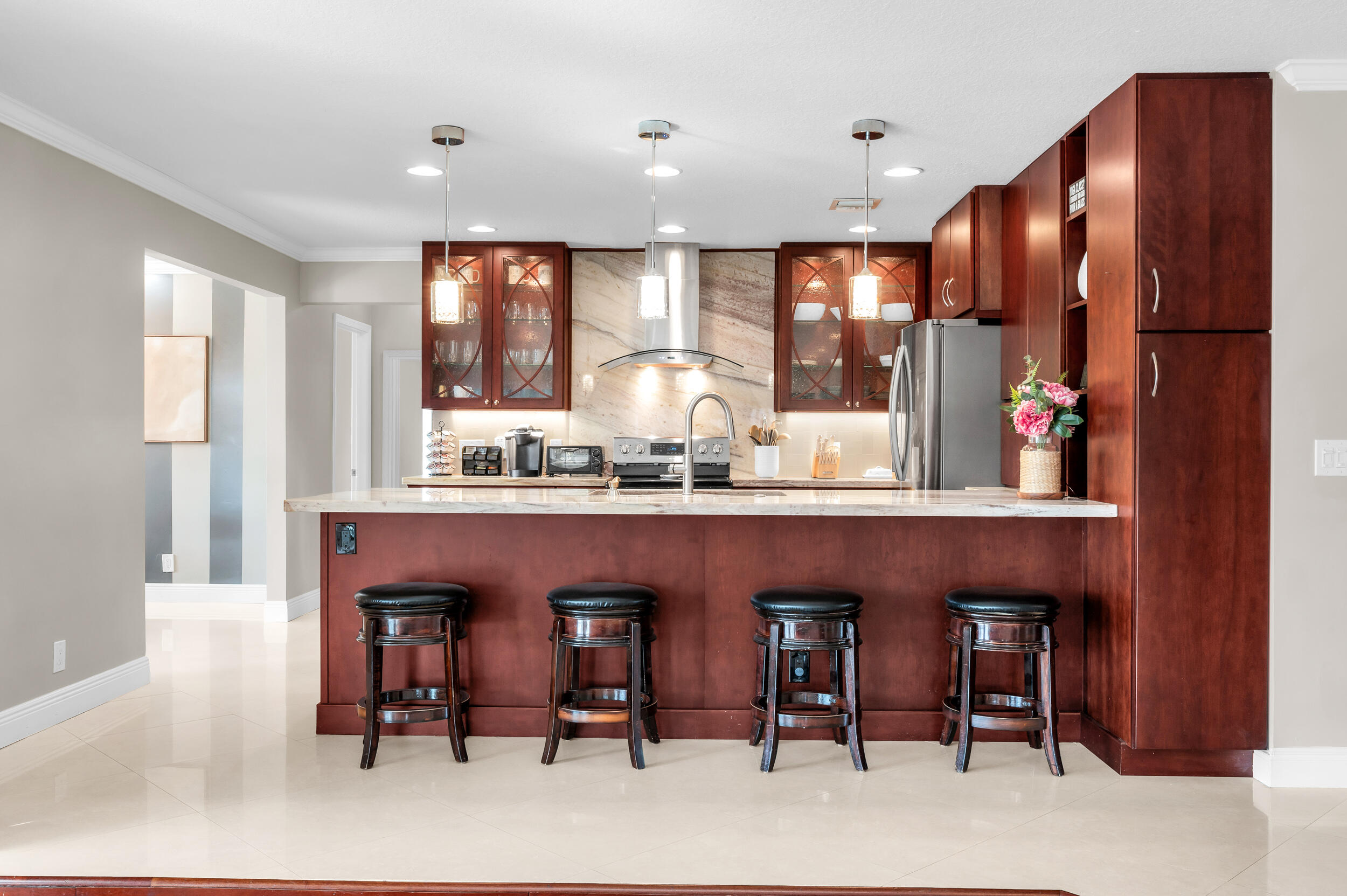3250 Lakeview Boulevard Delray Beach, FL 33445 - Photo 9 of 26 a kitchen with stainless steel appliances granite countertop a table chairs sink refrigerator and microwave