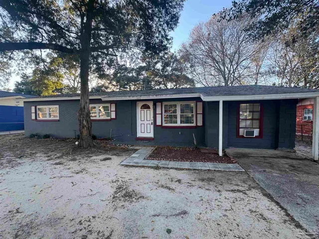a front view of a house with a garden