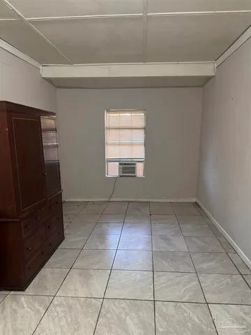 a view of kitchen with white cabinets and refrigerator