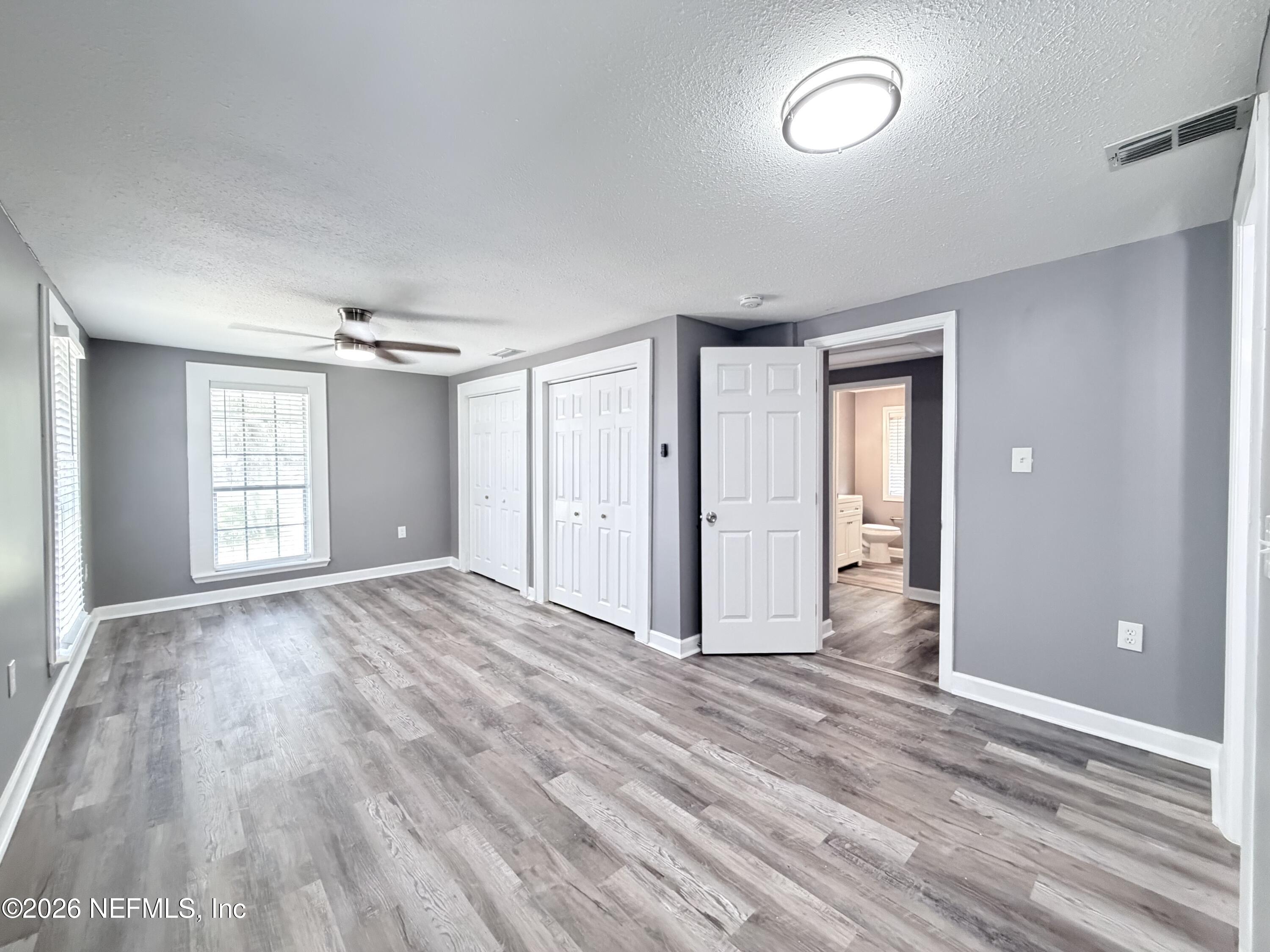 5336 Cruz Road Jacksonville, FL 32207 - Photo 21 of 29 a view of empty room with wooden floor and fan