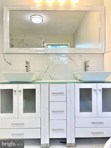 a bathroom with a bathtub and shower