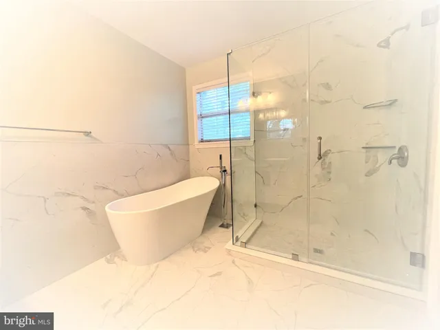 a bathroom with a shower toilet and sink