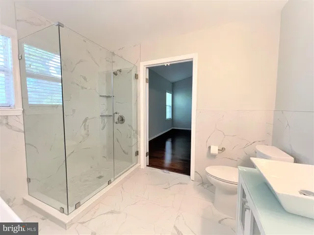 a bathroom with a sink a toilet and mirror