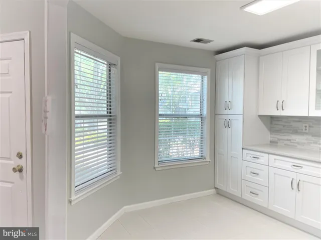 a view of a kitchen with dishwasher and window