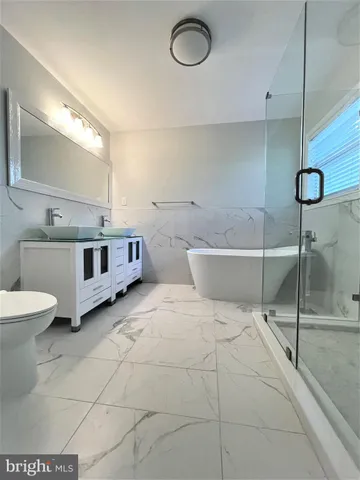 a bathroom with a bathtub and shower