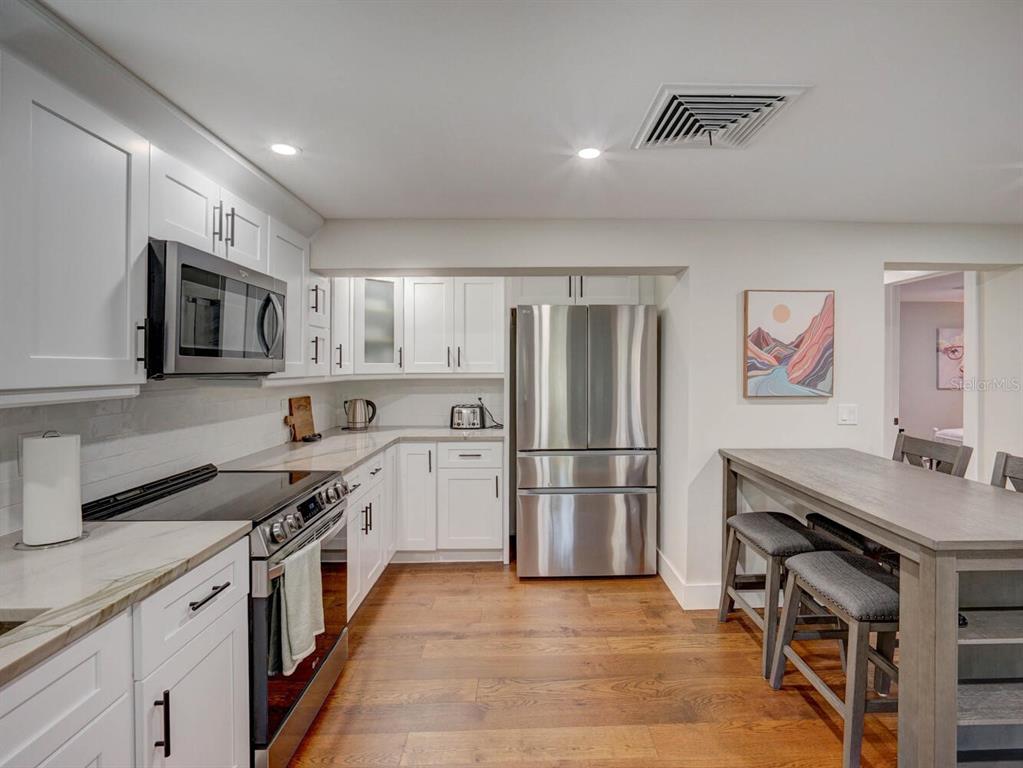 6746 River Road New Port Richey, FL 34652 - Photo 17 of 55 a kitchen with granite countertop a refrigerator stove top oven and sink