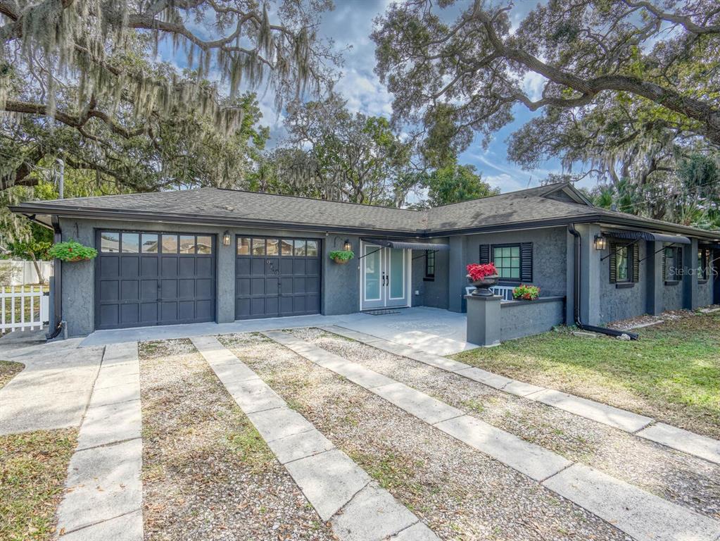 6746 River Road New Port Richey, FL 34652 - Photo 2 of 55 a view of a house with a patio and a yard