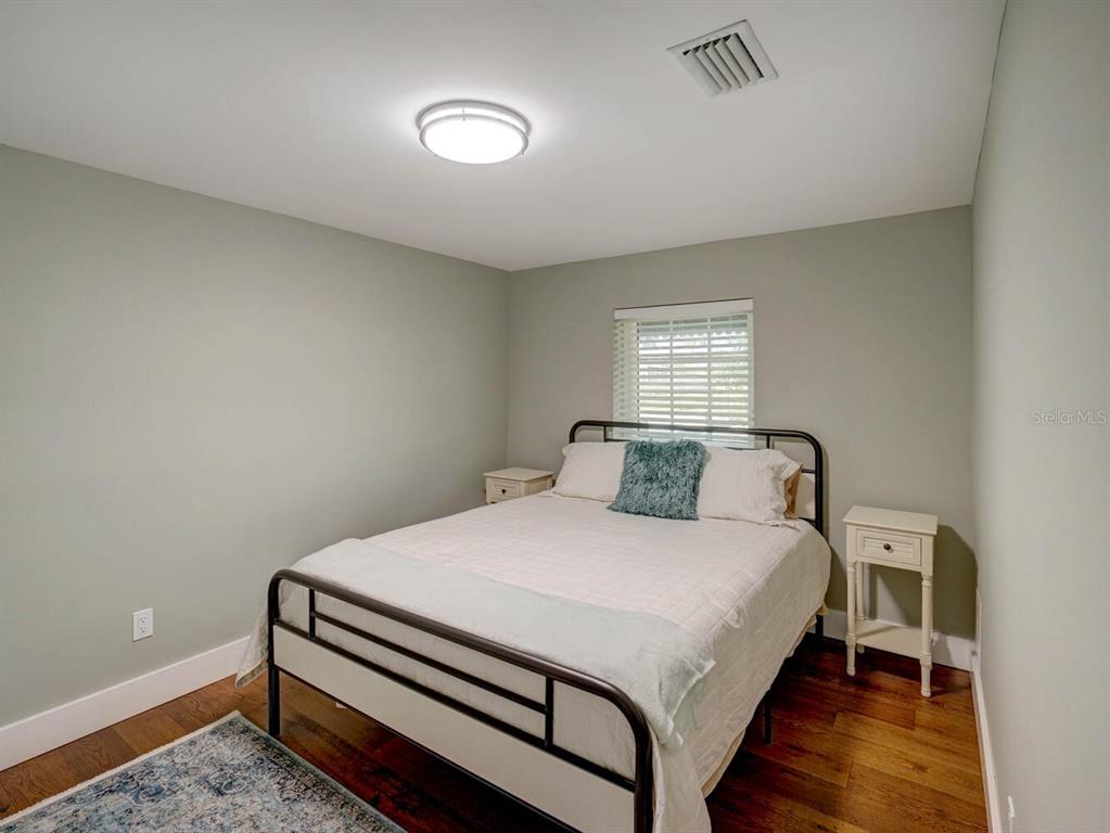 6746 River Road New Port Richey, FL 34652 - Photo 23 of 55 a bedroom with a bed and a lamp