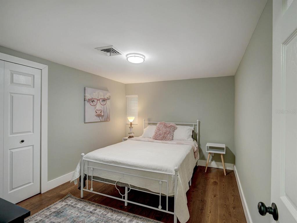 6746 River Road New Port Richey, FL 34652 - Photo 25 of 55 a bedroom with a bed and a table in it