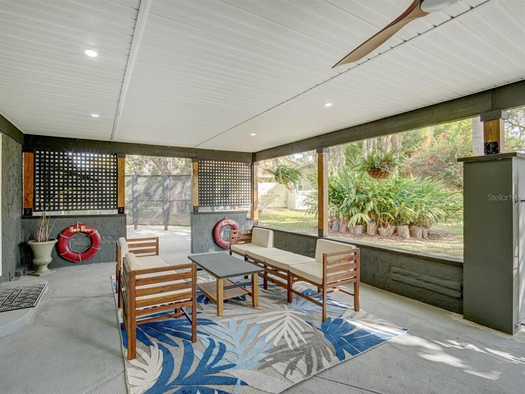6746 River Road New Port Richey, FL 34652 - Photo 30 of 55 a living room with furniture and a floor to ceiling window