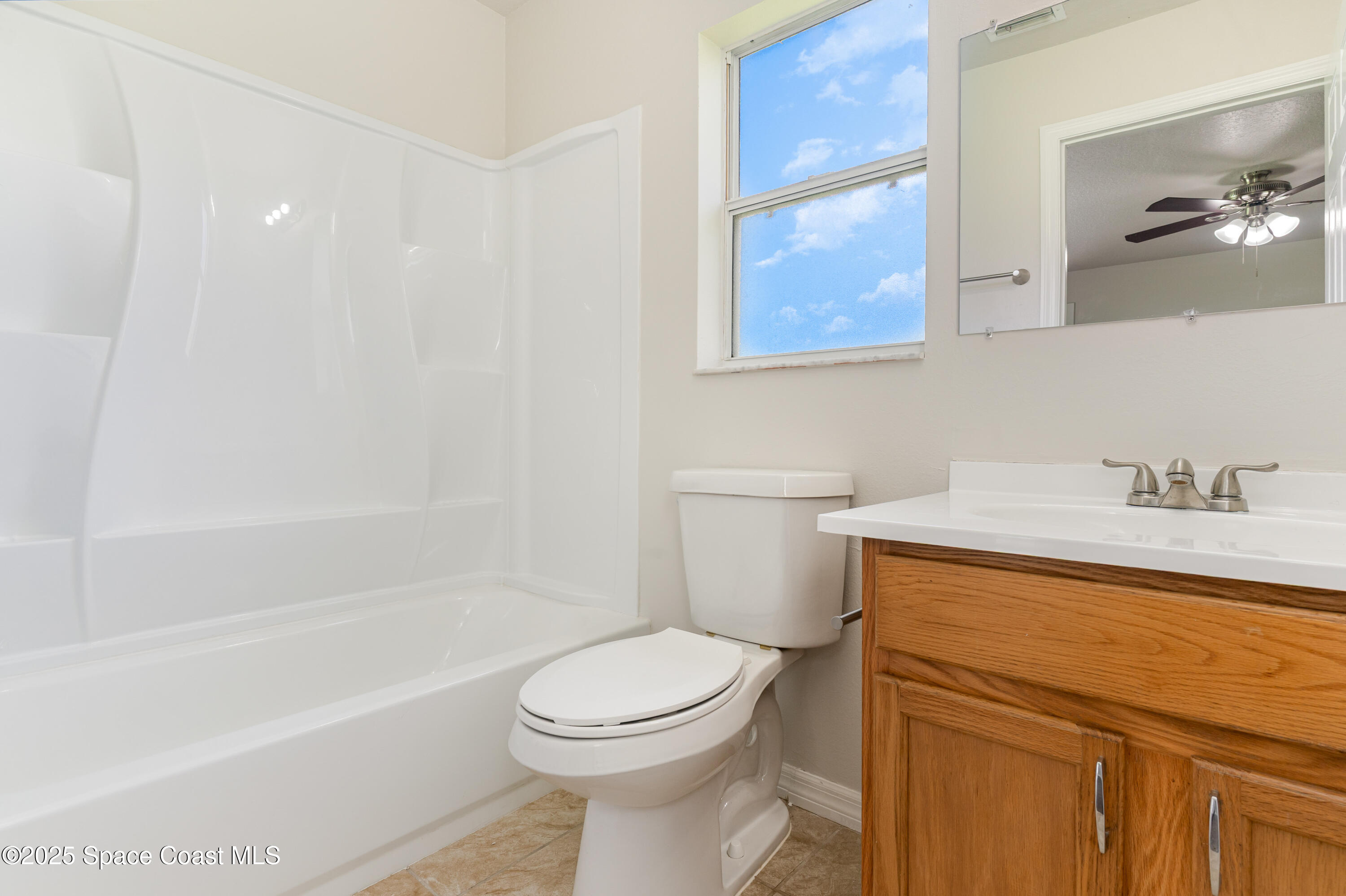 774 Fletcher Road Southeast Palm Bay, FL 32909 - Photo 11 of 20 a bathroom with a sink a toilet and bathtub