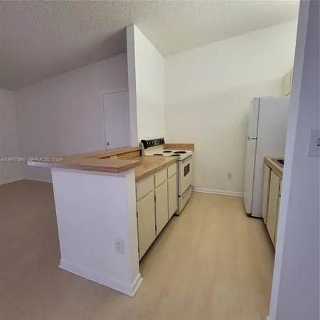 a utility room with cabinets washer and dryer