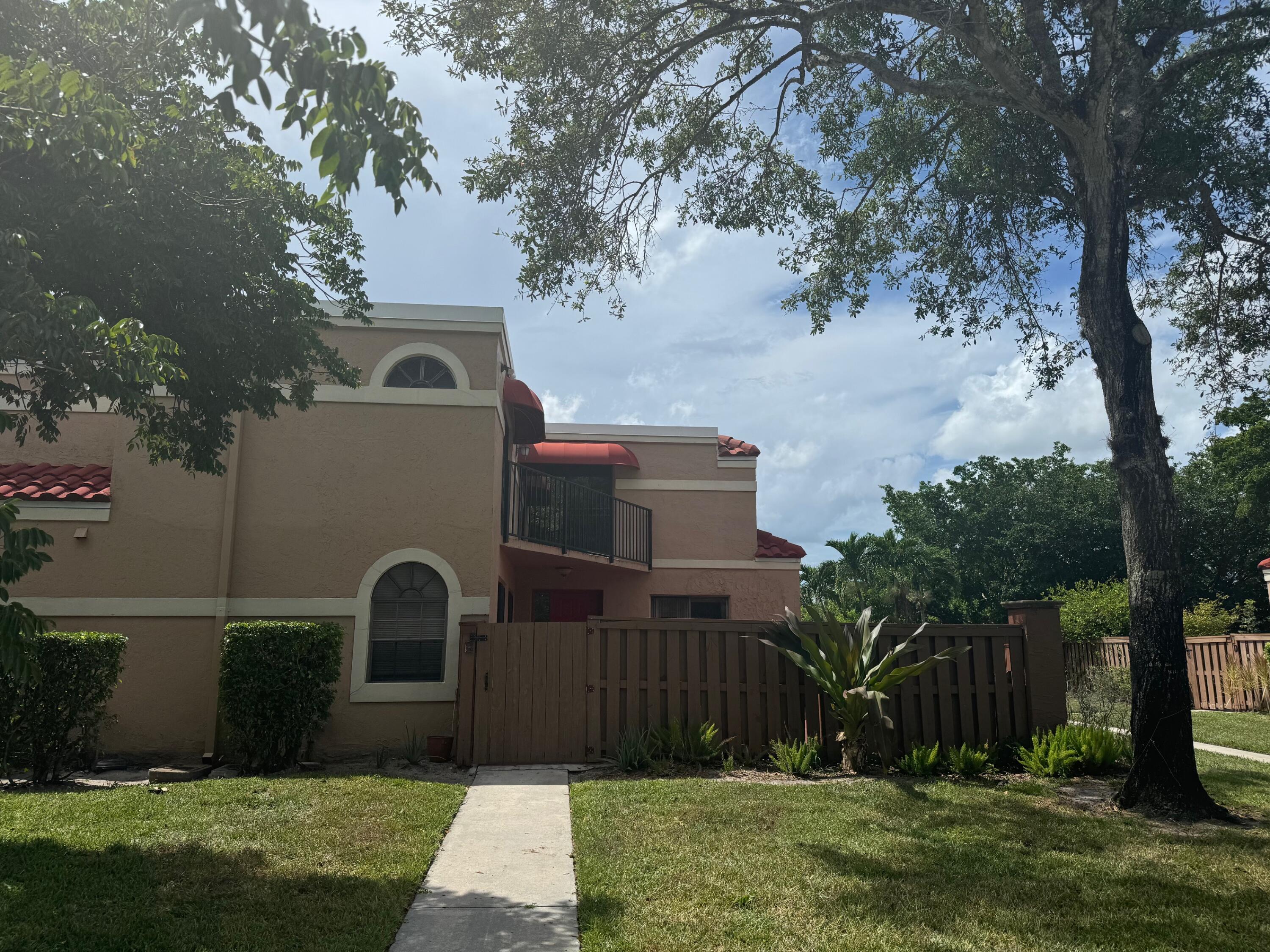 8068 Severn Drive, Unit B Boca Raton, FL 33433 - Photo 1 of 12 a front view of house with yard and trees
