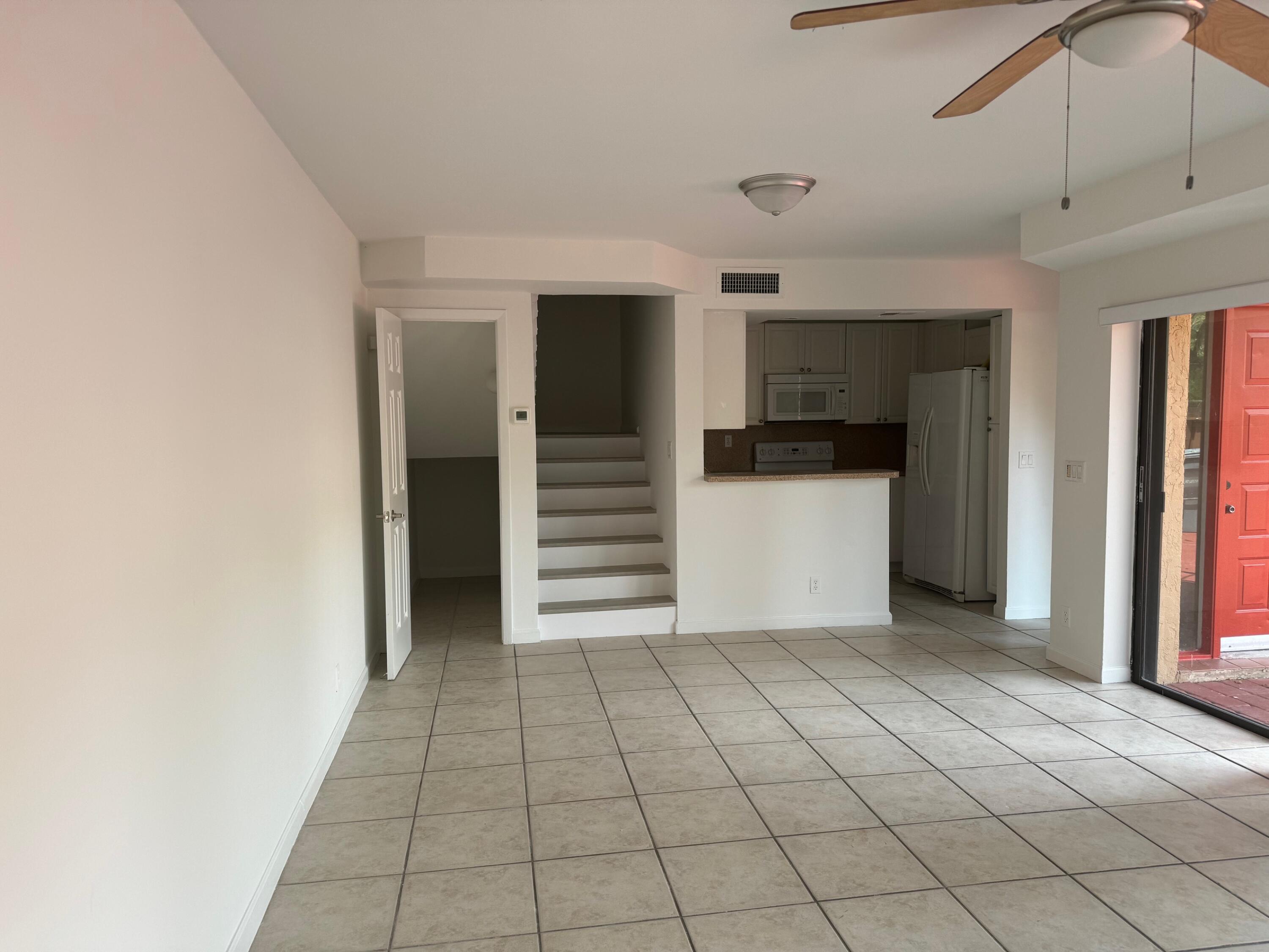 8068 Severn Drive, Unit B Boca Raton, FL 33433 - Photo 11 of 12 a view of a utility room with cabinets