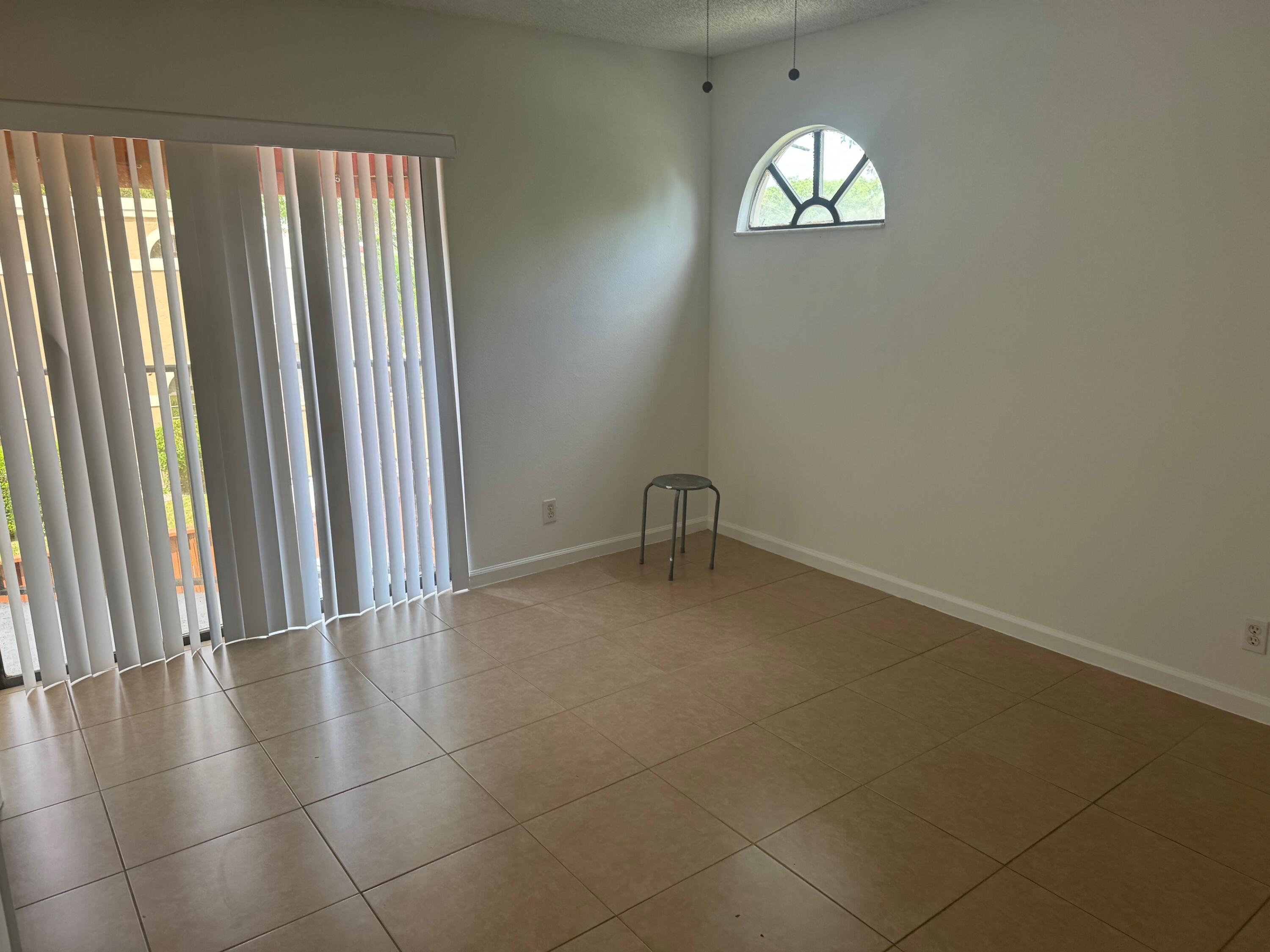 8068 Severn Drive, Unit B Boca Raton, FL 33433 - Photo 6 of 12 an empty room with windows