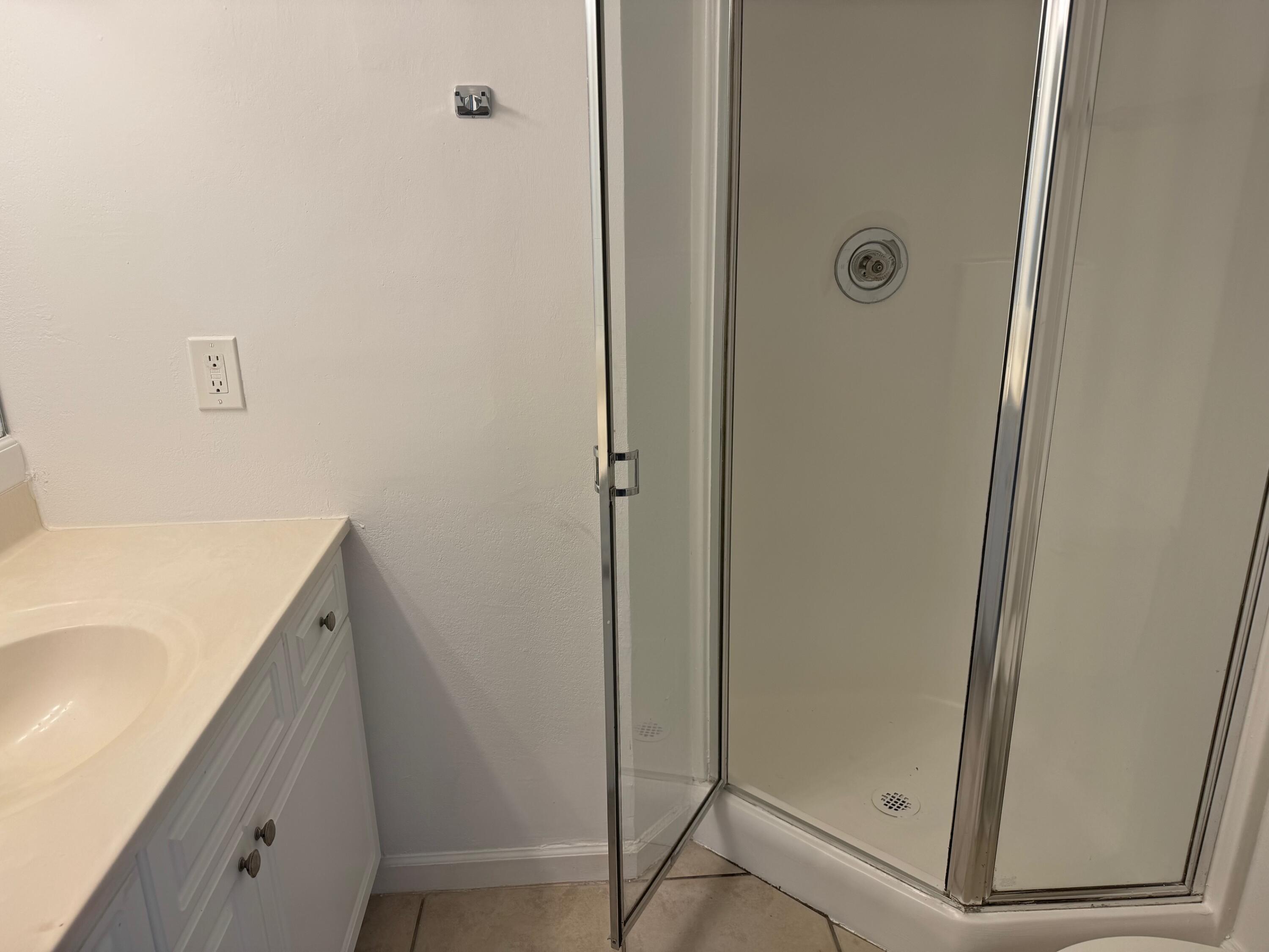 8068 Severn Drive, Unit B Boca Raton, FL 33433 - Photo 7 of 12 a bathroom with a tub and shower